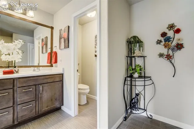 a view of a hallway with wooden floor and closet