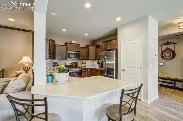 a kitchen with stainless steel appliances granite countertop a sink and stove top oven