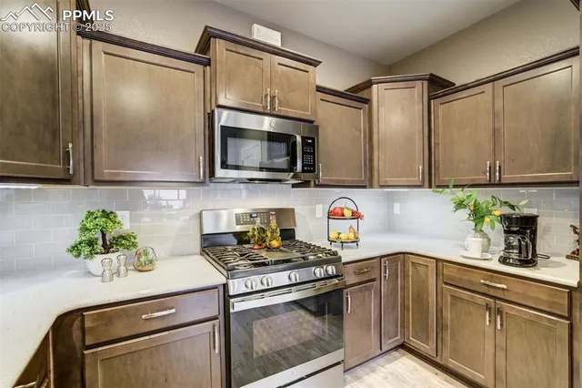 a kitchen with a sink and stove