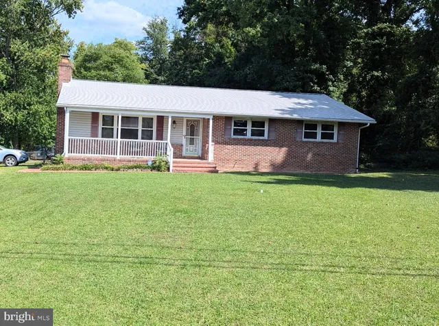 a aerial view of a house next to a big yard