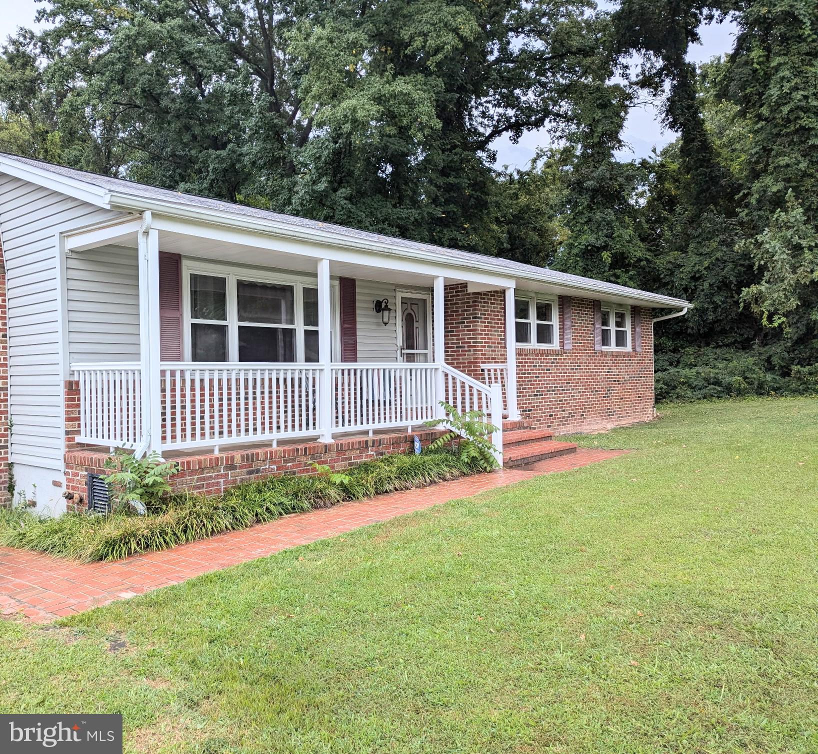 5807 Farmview Avenue Baltimore, MD 21206 - Photo 13 of 14 a front view of a house with a garden and yard