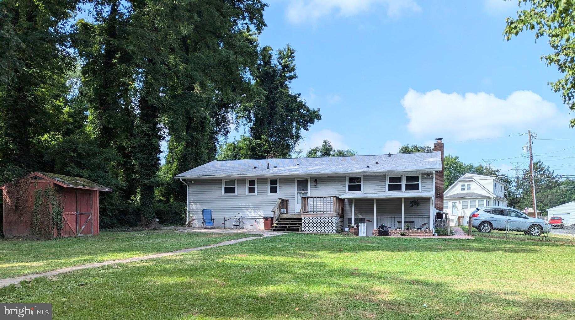 5807 Farmview Avenue Baltimore, MD 21206 - Photo 14 of 14 a view of a house with a big yard and large trees