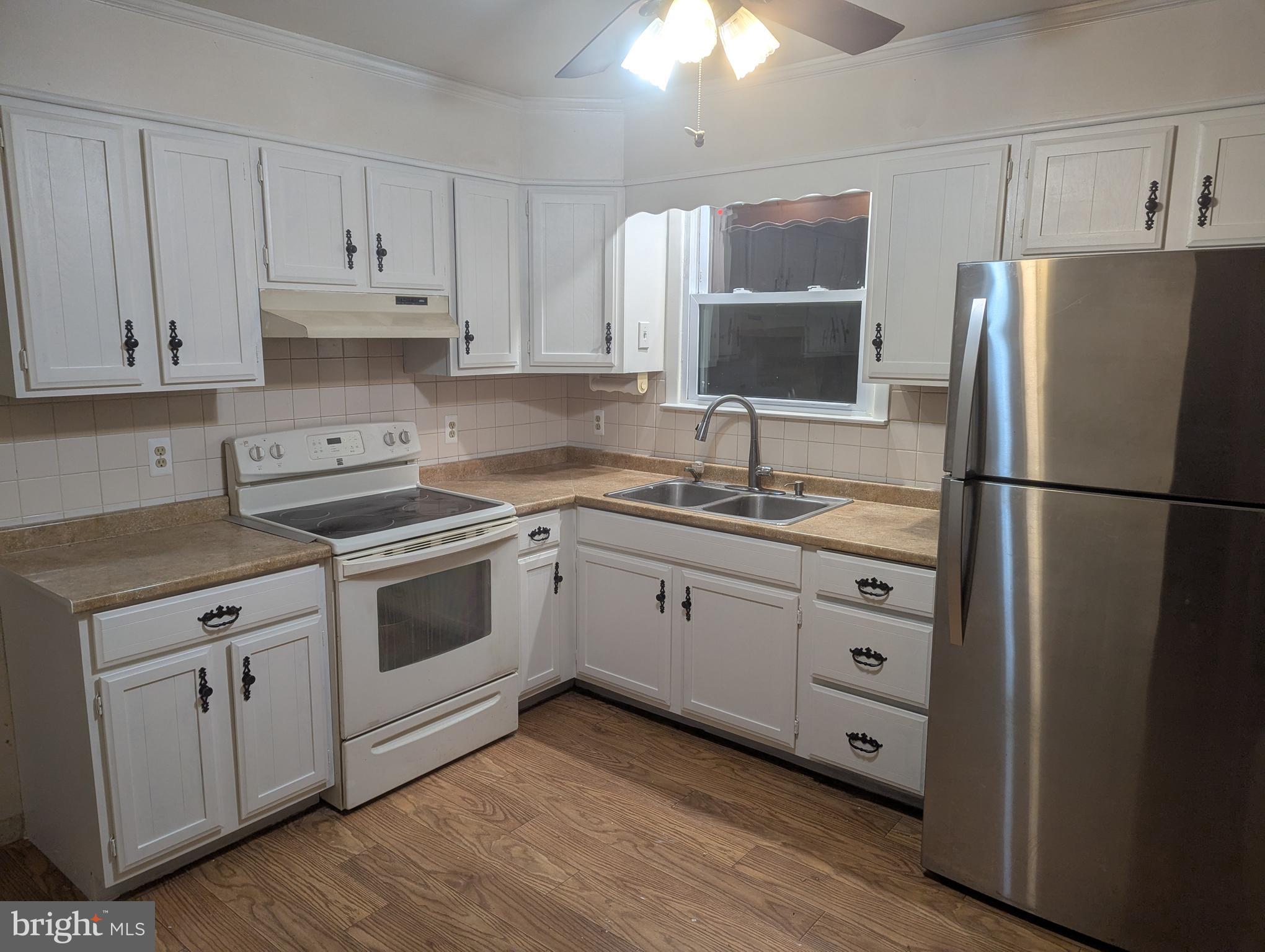 5807 Farmview Avenue Baltimore, MD 21206 - Photo 3 of 14 a kitchen with cabinets appliances and a window