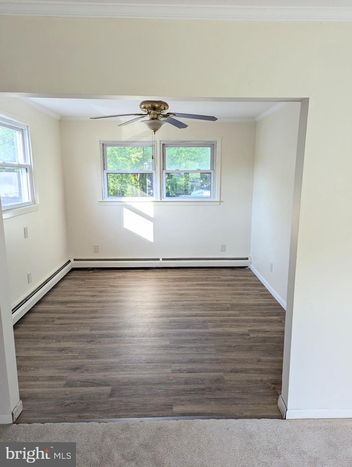 5807 Farmview Avenue Baltimore, MD 21206 - Photo 5 of 14 an empty room with wooden floor and windows