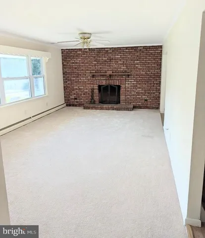 a view of empty room with a fireplace