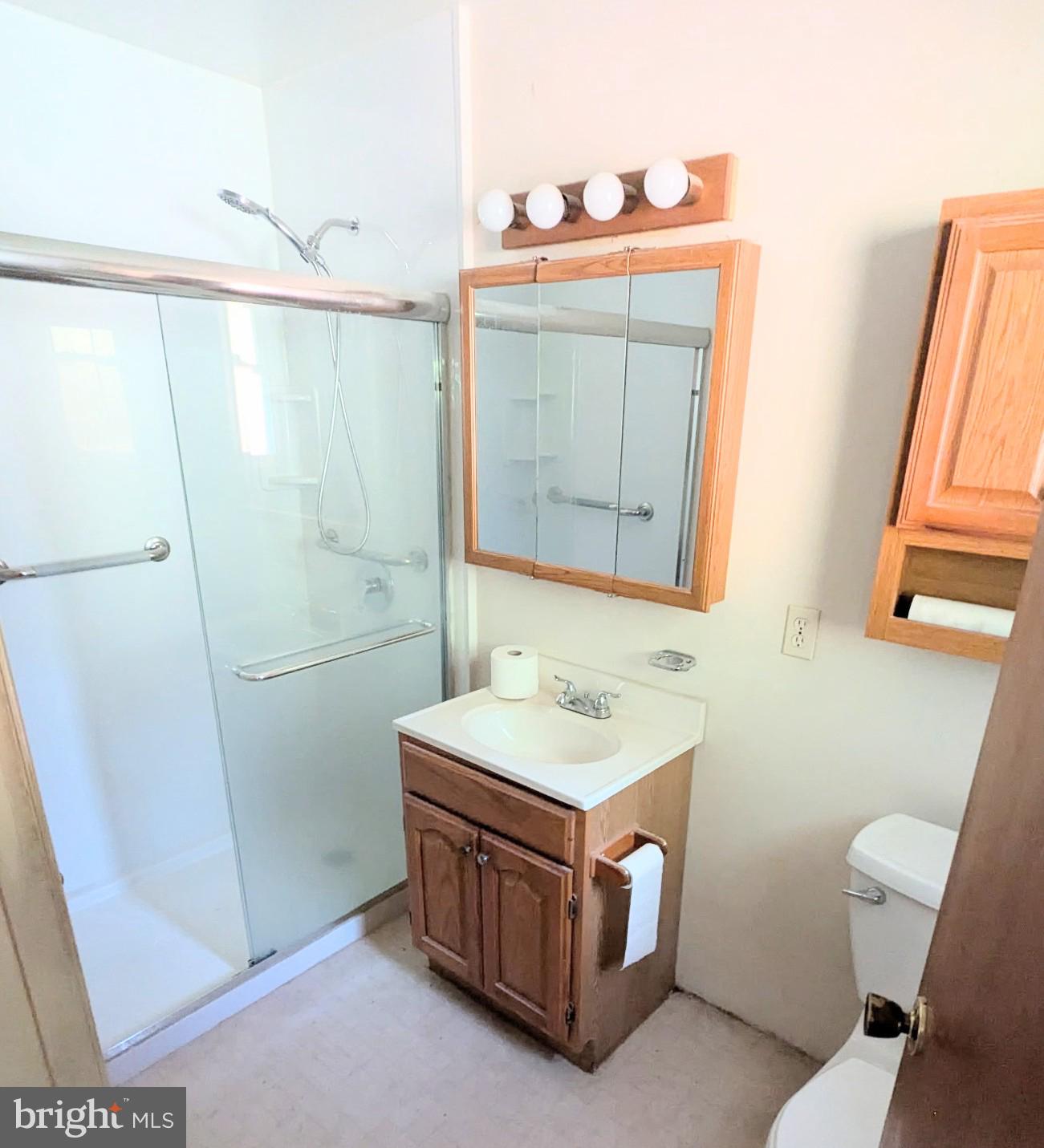 5807 Farmview Avenue Baltimore, MD 21206 - Photo 9 of 14 a bathroom with a sink a toilet and mirror