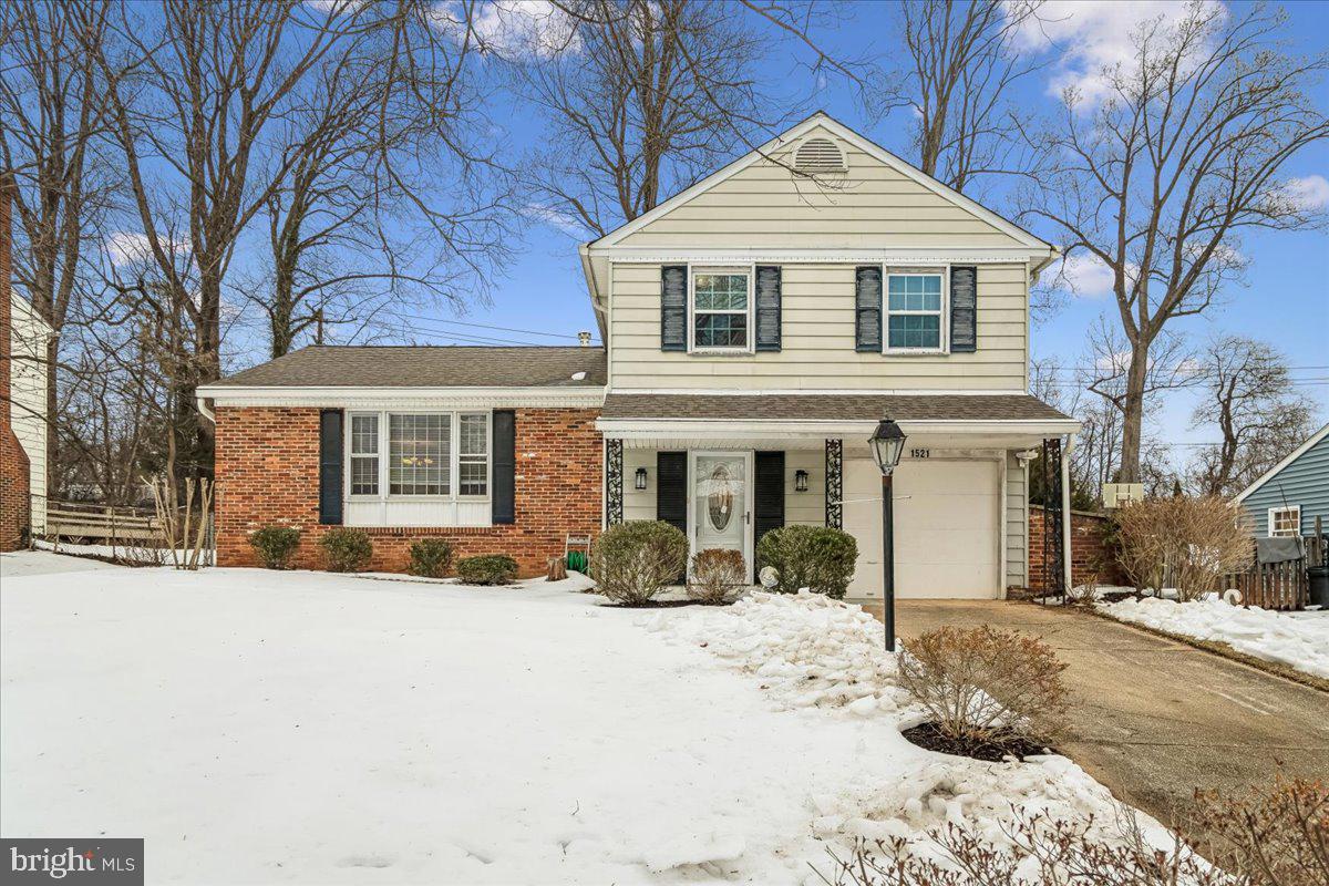 1521 Billman Lane Silver Spring, MD 20902 - Photo 1 of 33 a front view of a house with a yard covered in snow