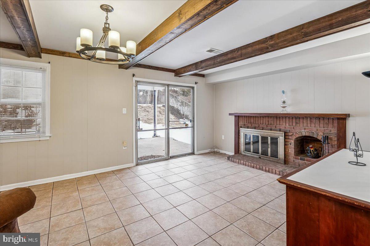 1521 Billman Lane Silver Spring, MD 20902 - Photo 12 of 33 a view of a livingroom with a fireplace a chandelier and wooden floor