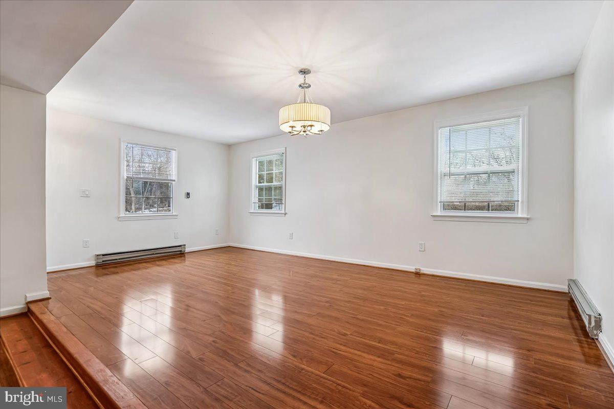 1521 Billman Lane Silver Spring, MD 20902 - Photo 15 of 33 a view of an empty room with wooden floor and a window