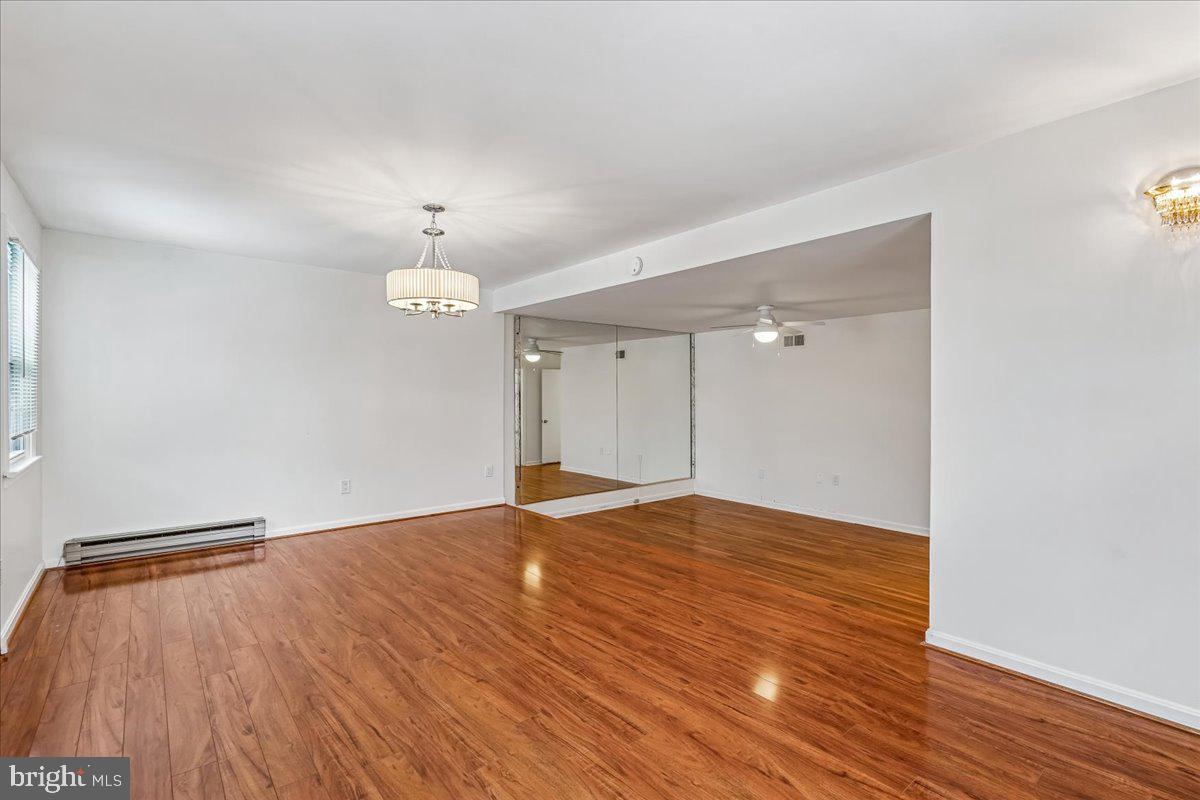 1521 Billman Lane Silver Spring, MD 20902 - Photo 16 of 33 a view of an empty room with wooden floor and a window