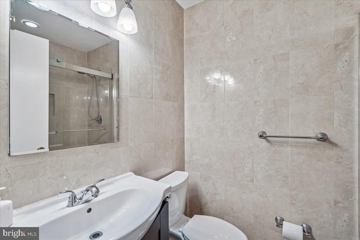 1521 Billman Lane Silver Spring, MD 20902 - Photo 19 of 33 a bathroom with a sink mirror and a toilet