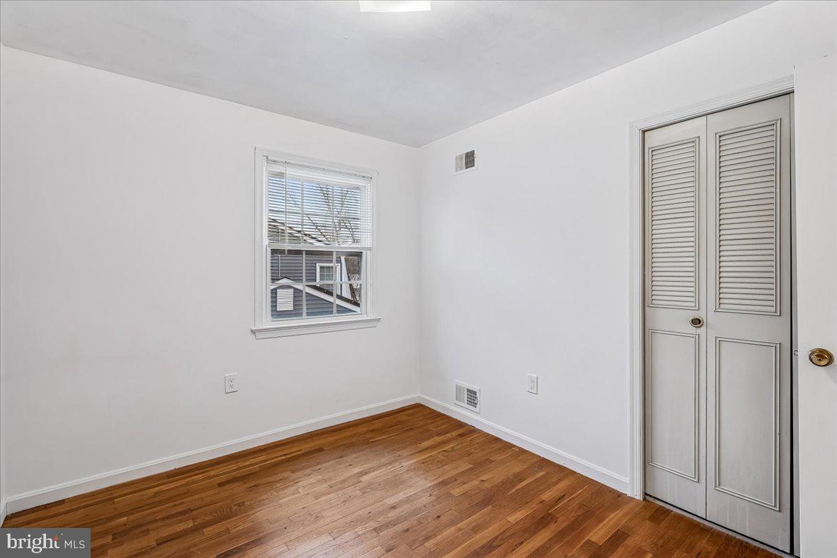 1521 Billman Lane Silver Spring, MD 20902 - Photo 21 of 33 a view of an empty room with wooden floor and a window