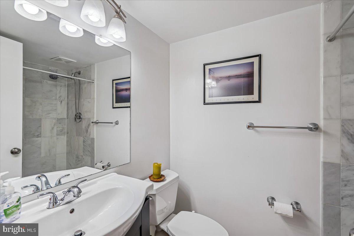 1521 Billman Lane Silver Spring, MD 20902 - Photo 24 of 33 a bathroom with a sink mirror vanity and toilet