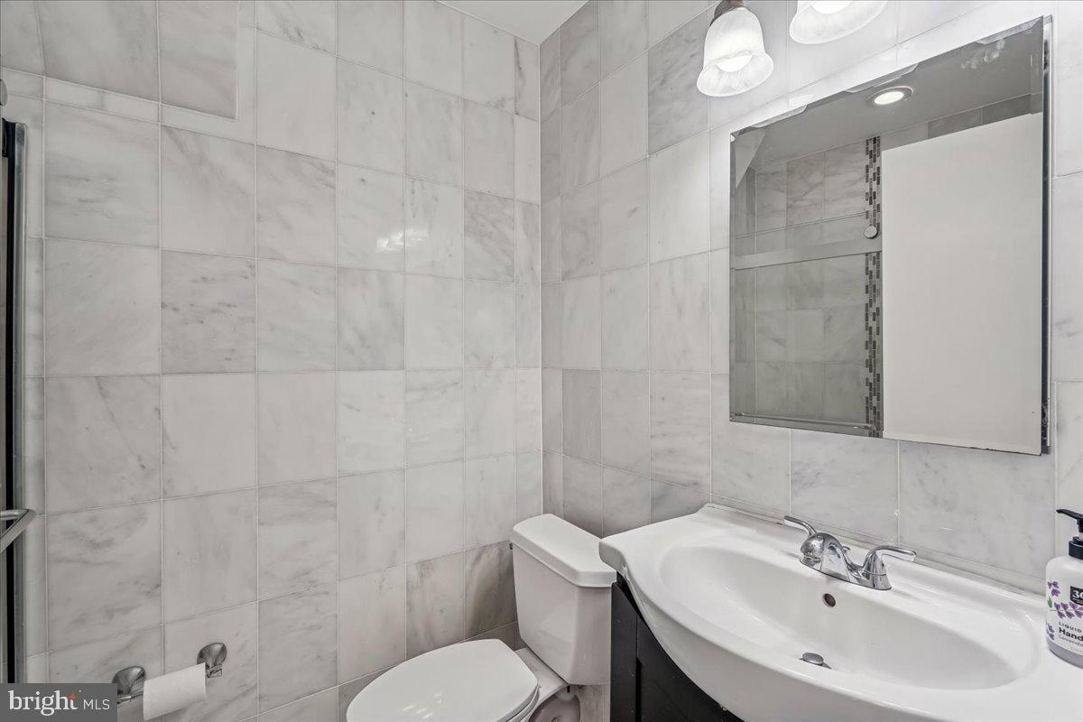 1521 Billman Lane Silver Spring, MD 20902 - Photo 29 of 33 a bathroom with a sink a toilet and shower