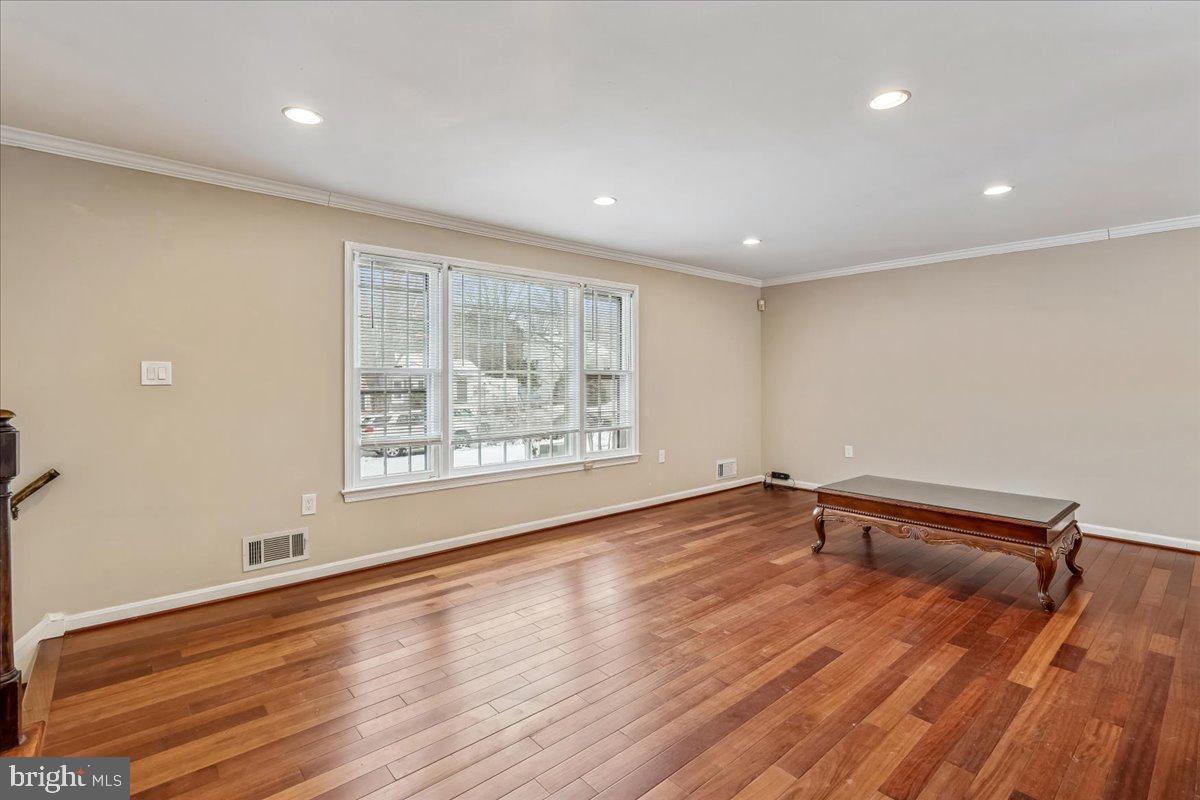 1521 Billman Lane Silver Spring, MD 20902 - Photo 7 of 33 an empty room with wooden floor and windows