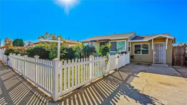 a view of a house with wooden fence