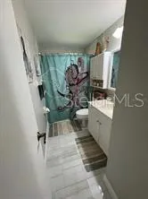 a bathroom with a sink toilet and mirror