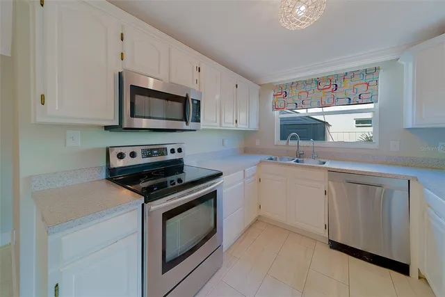 a kitchen with a sink cabinets and window
