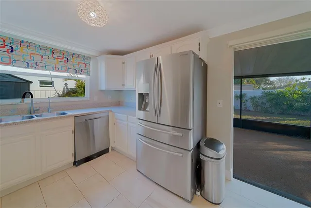a kitchen with stainless steel appliances granite countertop a refrigerator and a stove