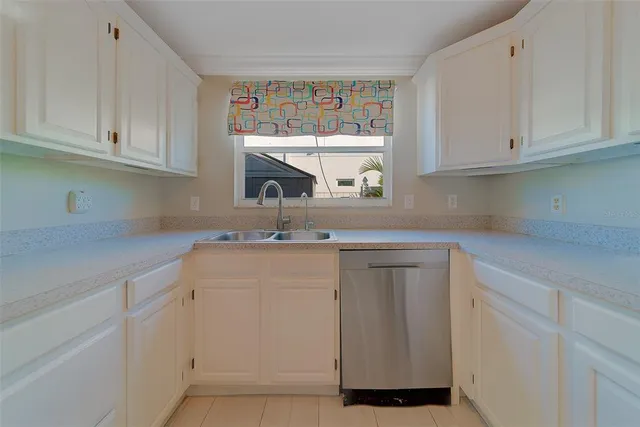 an empty room with wooden floor chandelier fan and windows