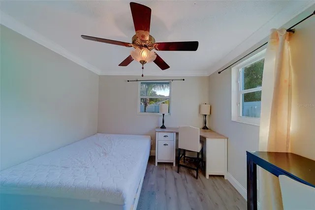 an empty room with windows and chandelier