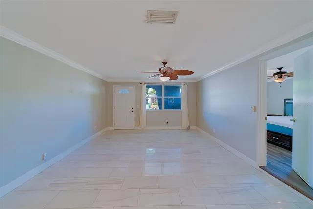 a bedroom with a bed table and window