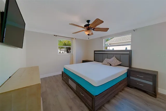 a bedroom with a bed and a chandelier