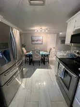 a kitchen with stainless steel appliances a stove a sink and a refrigerator