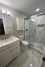 a bathroom with a double vanity sink toilet and a mirror