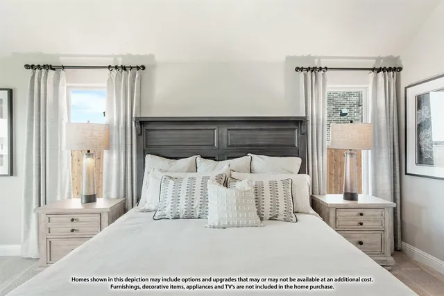 a bedroom with a large bed and a chandelier