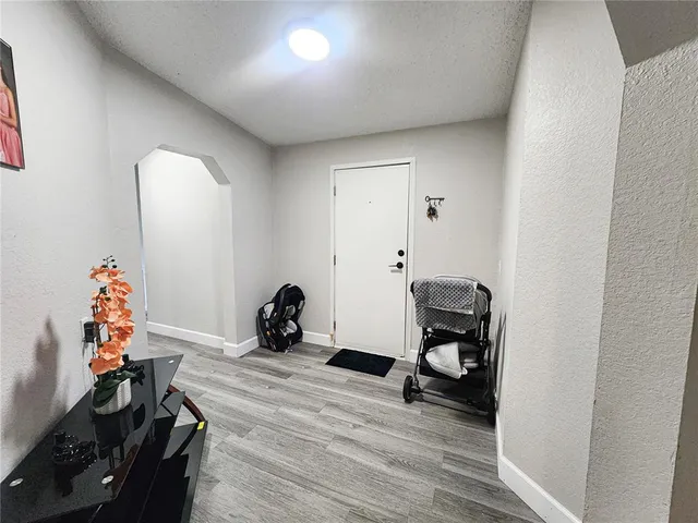 a view of a hallway view with wooden floor and staircase