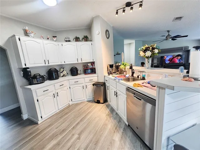 a bedroom with a bed and a flat tv screen on dresser