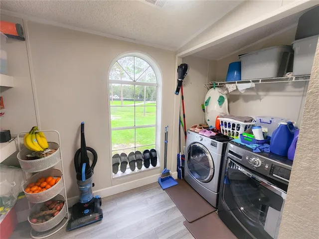 a view of a hallway with bathroom and mirror