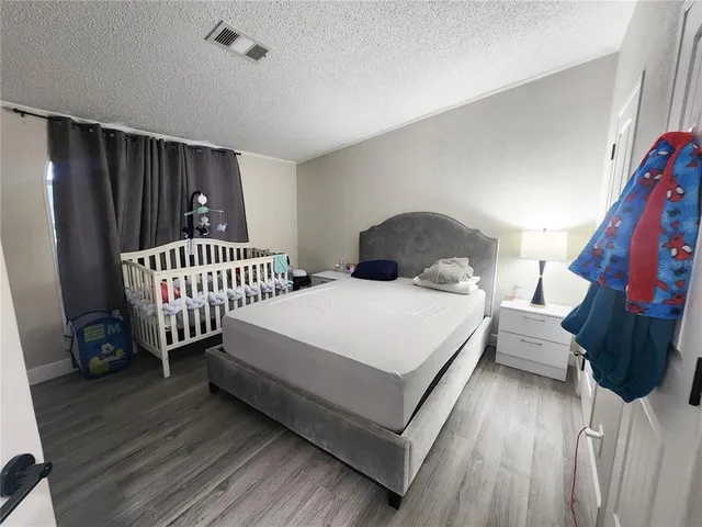 a bedroom with a bed and cabinets