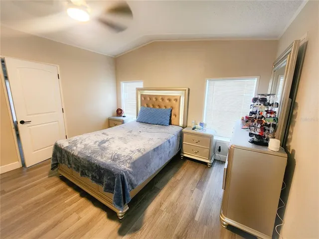 an aerial view of a house with a yard and large trees