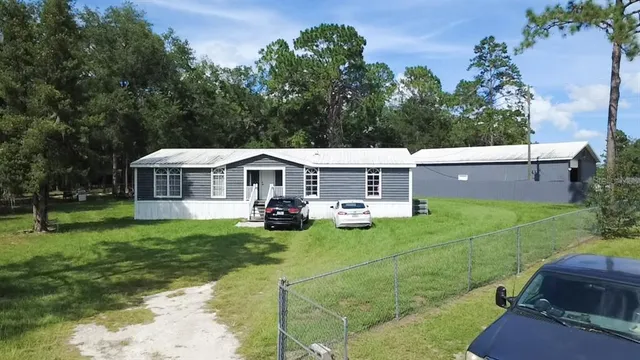 a view of a house with a big yard