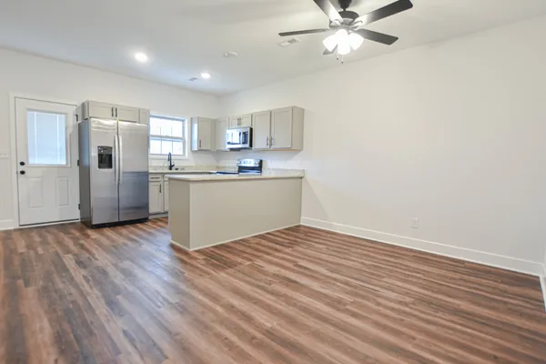 a view of kitchen with wooden floor and window