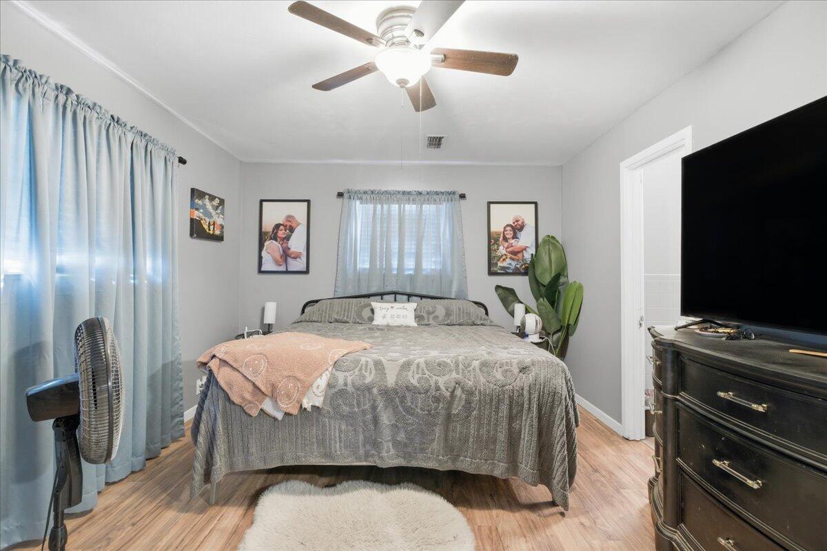 3816 44th Street Lubbock, TX 79413 - Photo 11 of 36 a bedroom with a bed and a flat screen tv