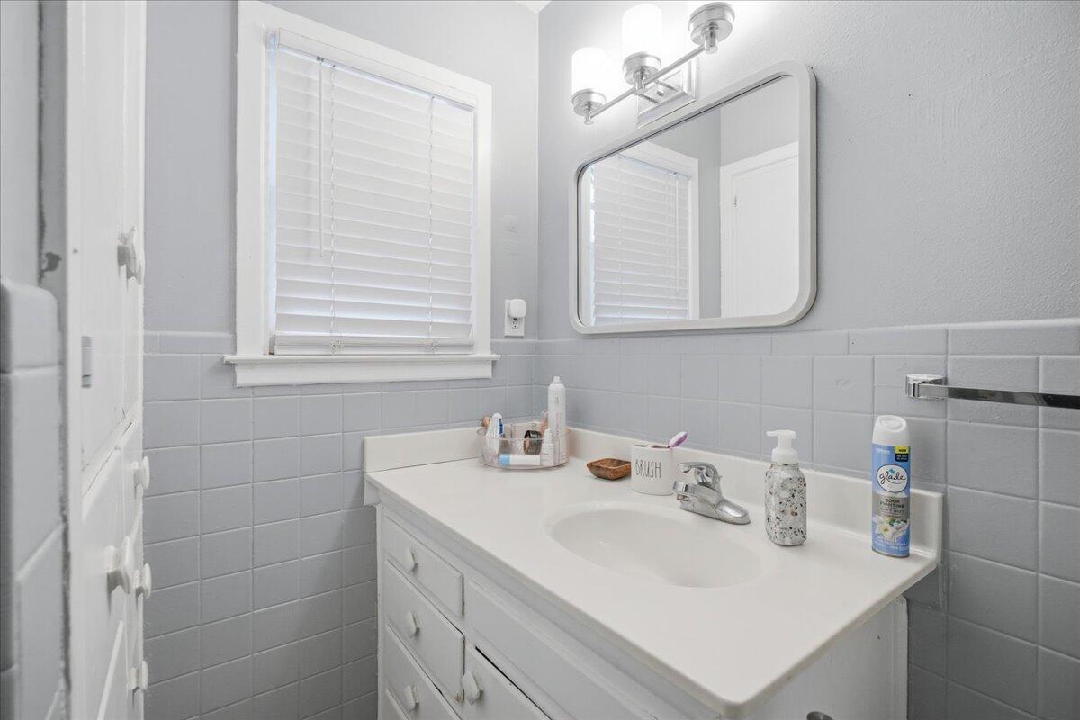 3816 44th Street Lubbock, TX 79413 - Photo 13 of 36 a bathroom with a sink vanity and a mirror