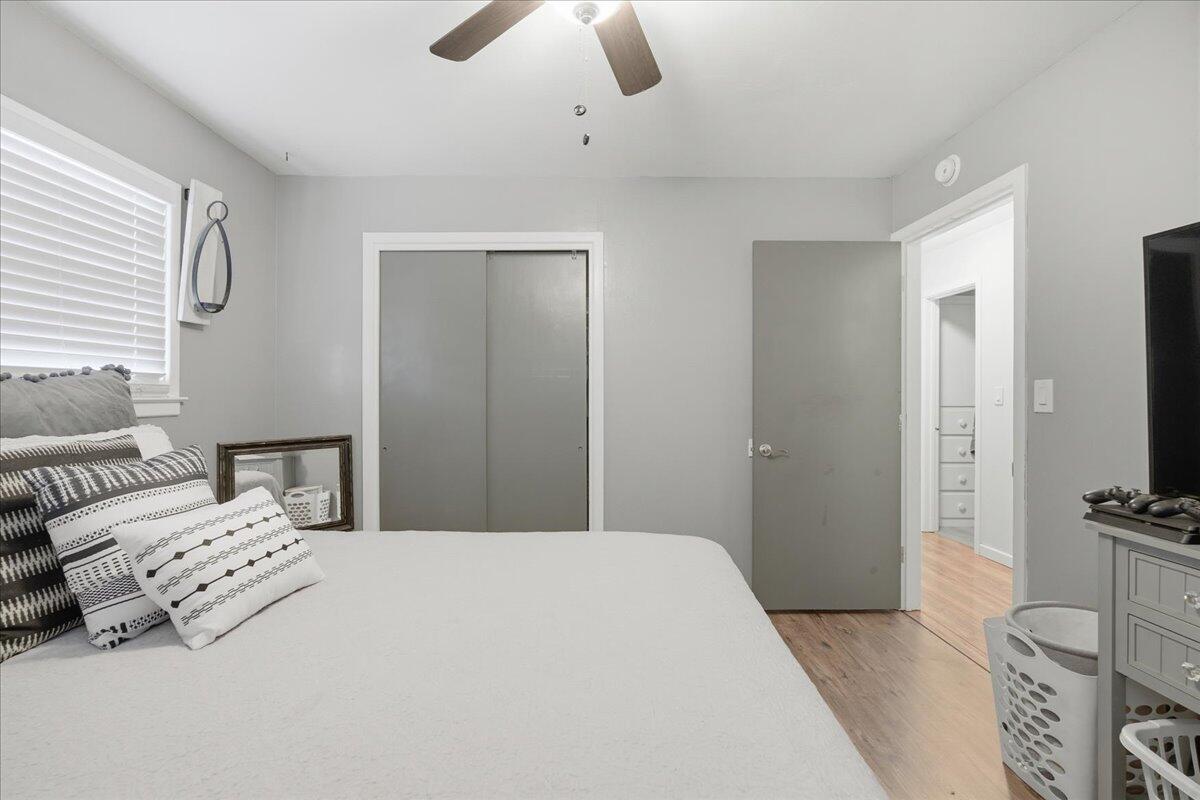 3816 44th Street Lubbock, TX 79413 - Photo 18 of 36 a bedroom with a bed a flat screen tv and dresser