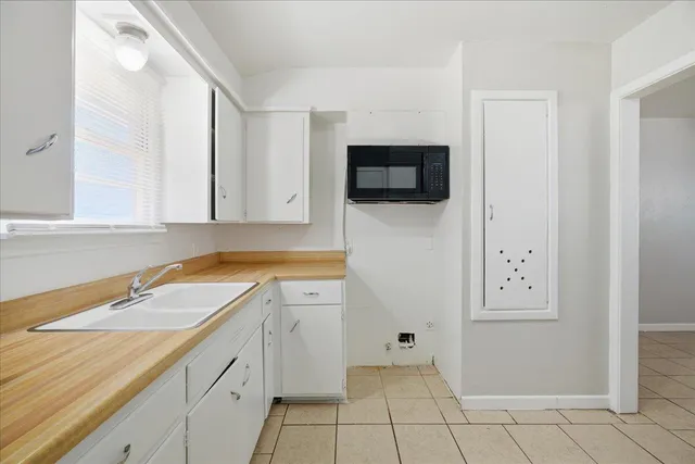 a spacious bathroom with a sink and a mirror