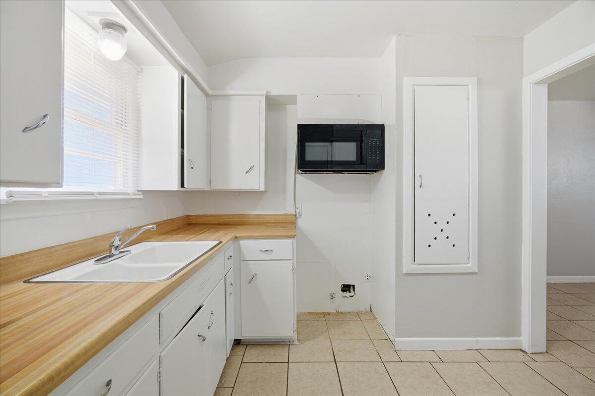 3816 44th Street Lubbock, TX 79413 - Photo 27 of 36 a spacious bathroom with a sink and a mirror