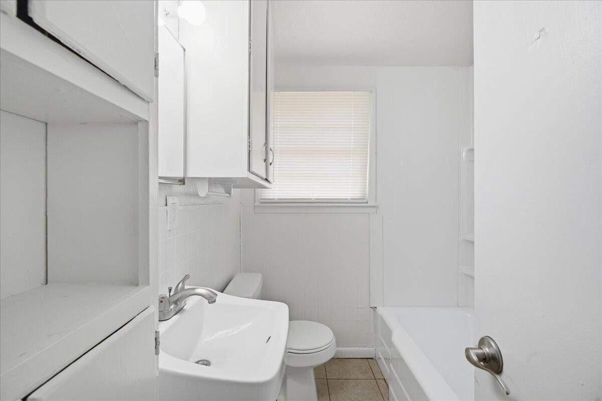 3816 44th Street Lubbock, TX 79413 - Photo 32 of 36 a bathroom with a sink and a mirror
