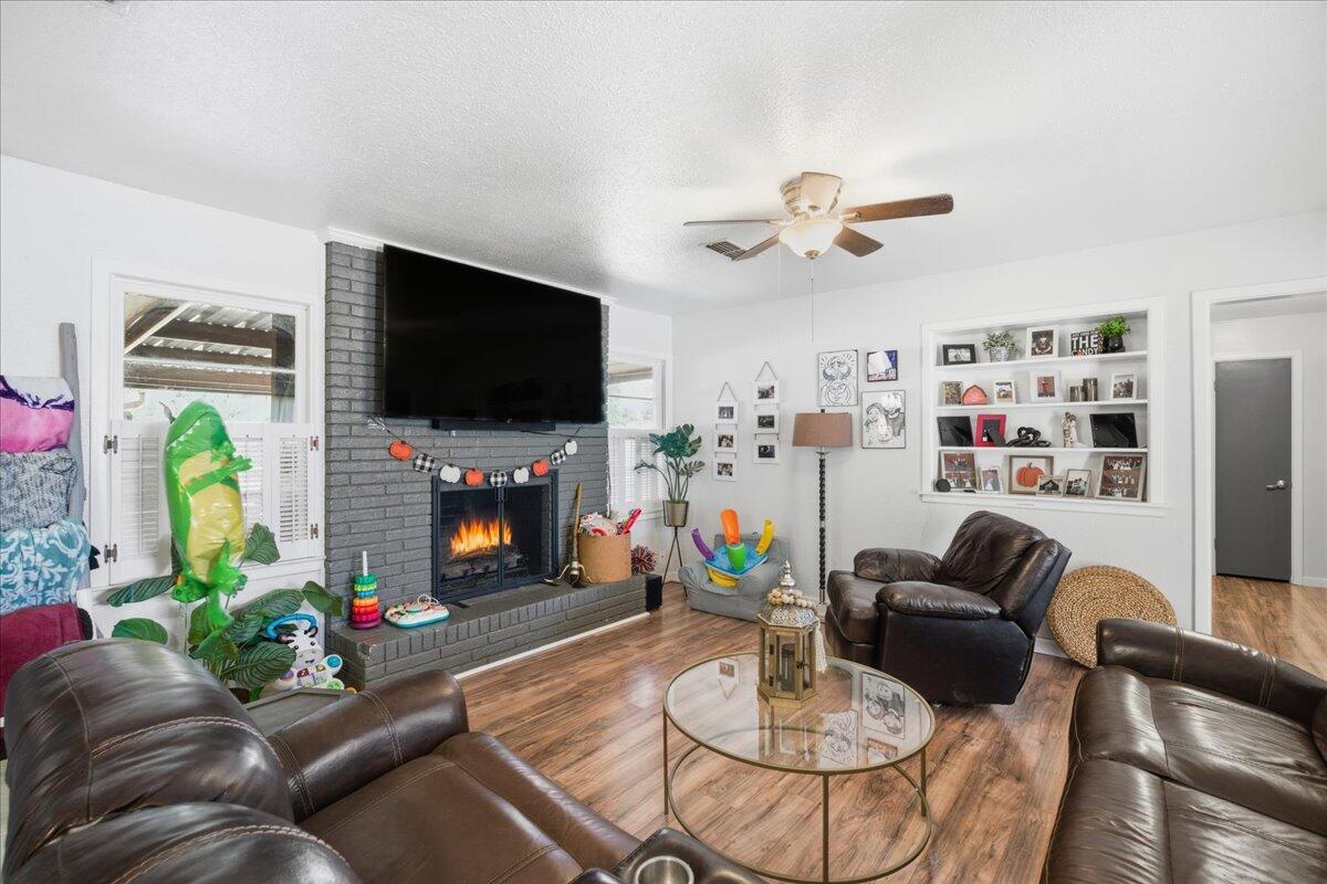 3816 44th Street Lubbock, TX 79413 - Photo 4 of 36 a living room with furniture and a flat screen tv