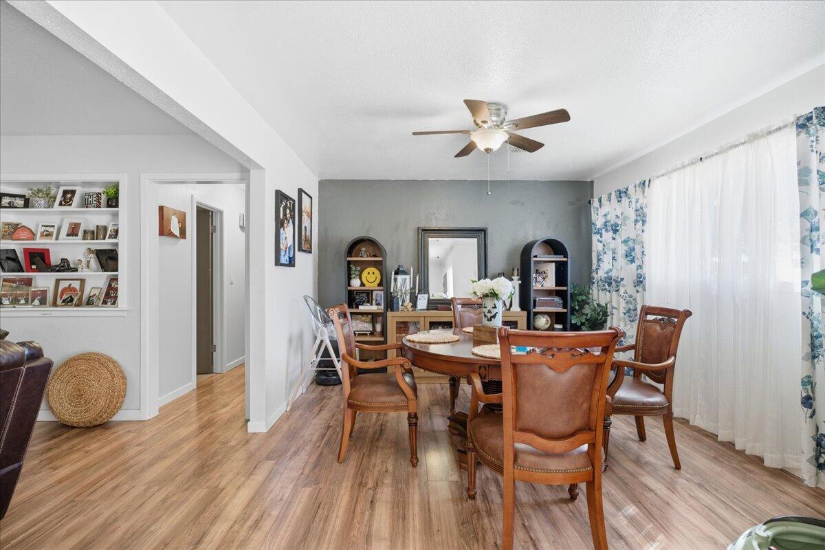 3816 44th Street Lubbock, TX 79413 - Photo 6 of 36 a view of a dining room with furniture and wooden floor