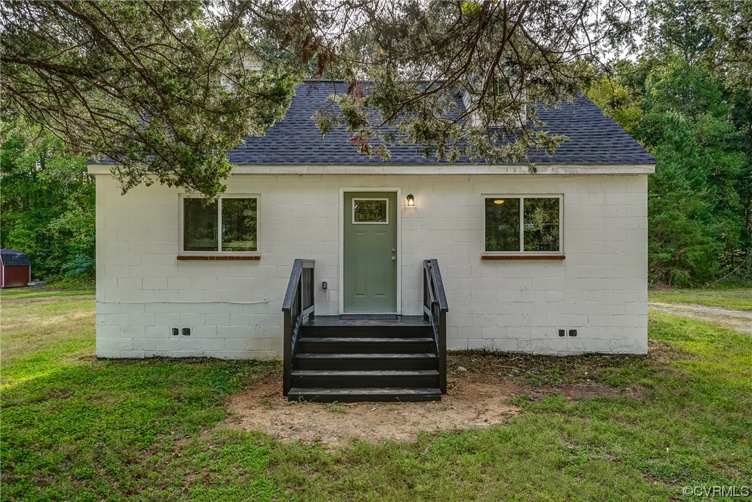 a view of a house with backyard and a garden