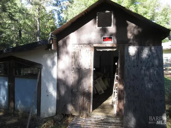 a view of a house with a yard and sitting area