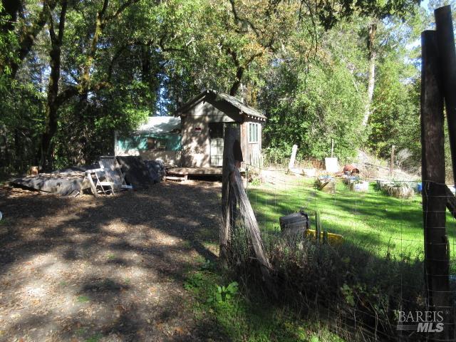 20515 Fort Ross Road Cazadero, CA 95421 - Photo 8 of 17 a backyard of a house with table and chairs