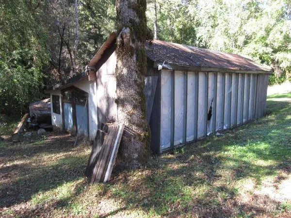 a view of a house with a yard and sitting area
