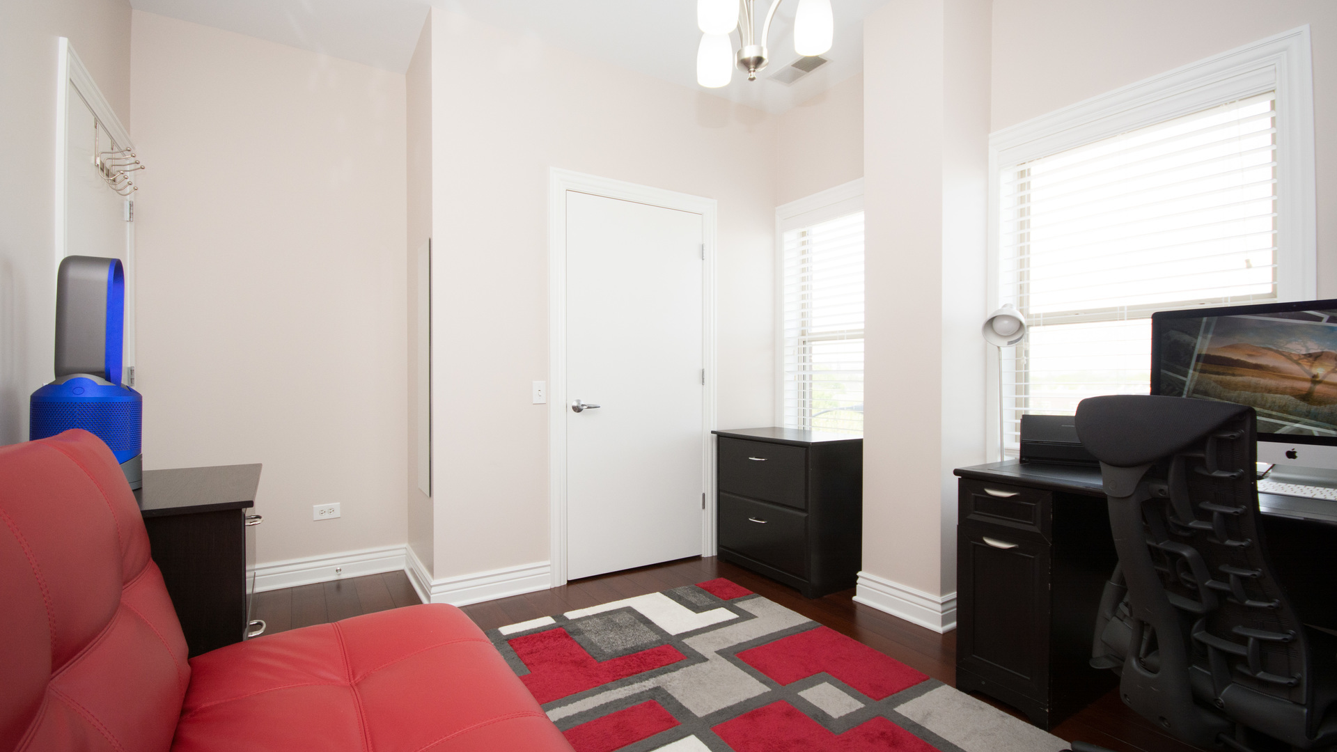 1155 West Roosevelt Road, Unit 401 Chicago, IL 60608 - Photo 22 of 35 a bedroom with a bed and wooden floor